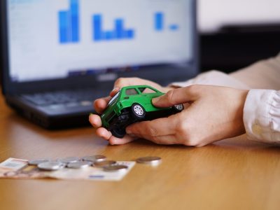 A closeup shot of a person thinking of buying a new car or selling a vehicle