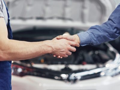 husband car mechanic and woman customer make an agreement on the repair of the car.